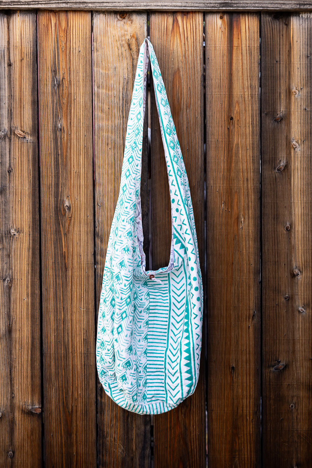 Unique, reversible slouch bag collection. Available in different patterns and colors. Green pattern on white design.