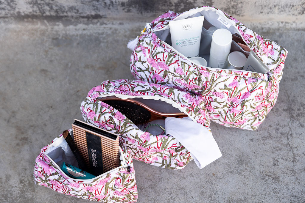 Set of three pink patterned cotton cosmetic bags. Smaller bags fit into the largest for easy storage. Detail