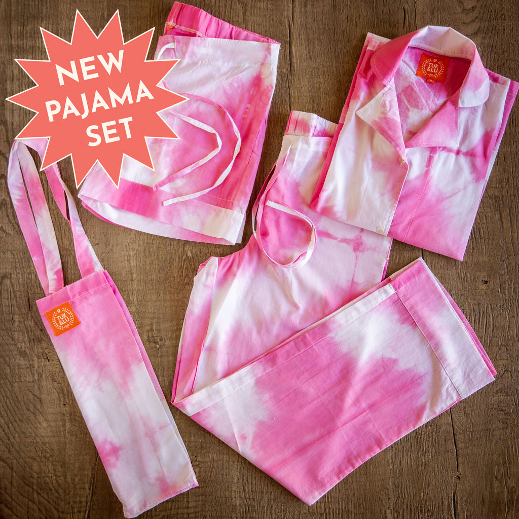 Four piece pink tie-dyed cotton pajama set featuring button down top, shorts, pants and matching tote.