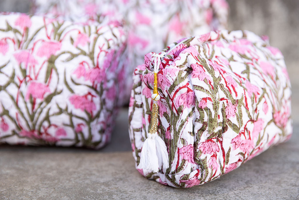 Detail of set of pink  patterned cotton cosmetic bags. 