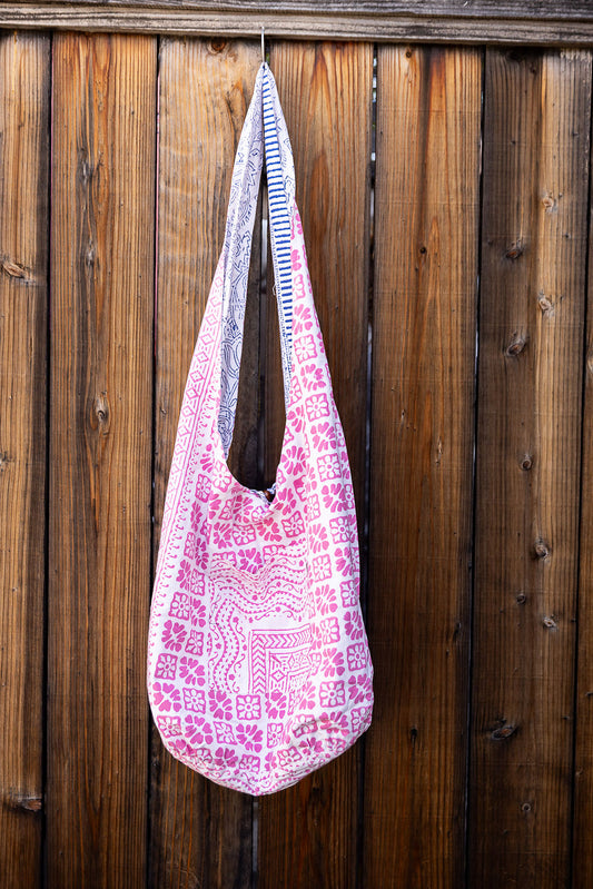 Unique slouch bag collection. Available in different patterns and colors. Pink pattern on white design.