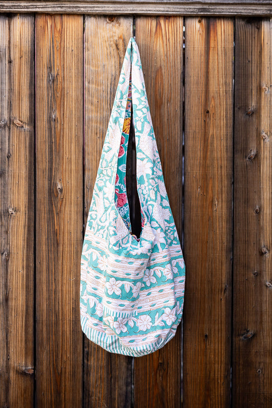 Unique, reversible slouch bag collection. Available in different patterns and colors. Multi-colored design.