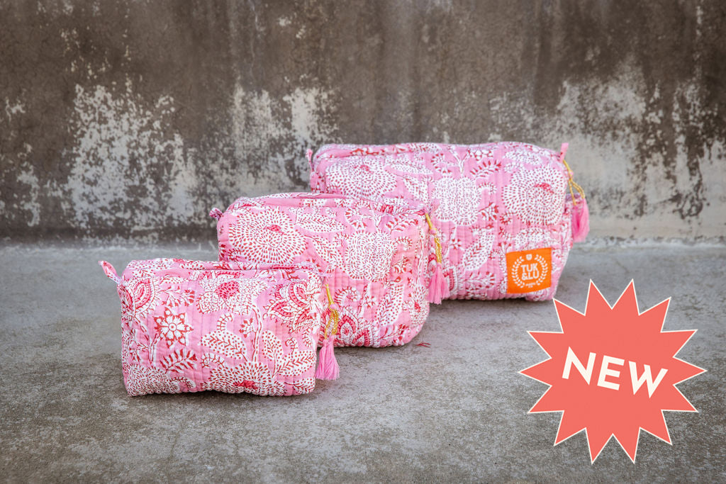 Set of three pink patterned cotton cosmetic bags. Smaller bags fit into the largest for easy storage.