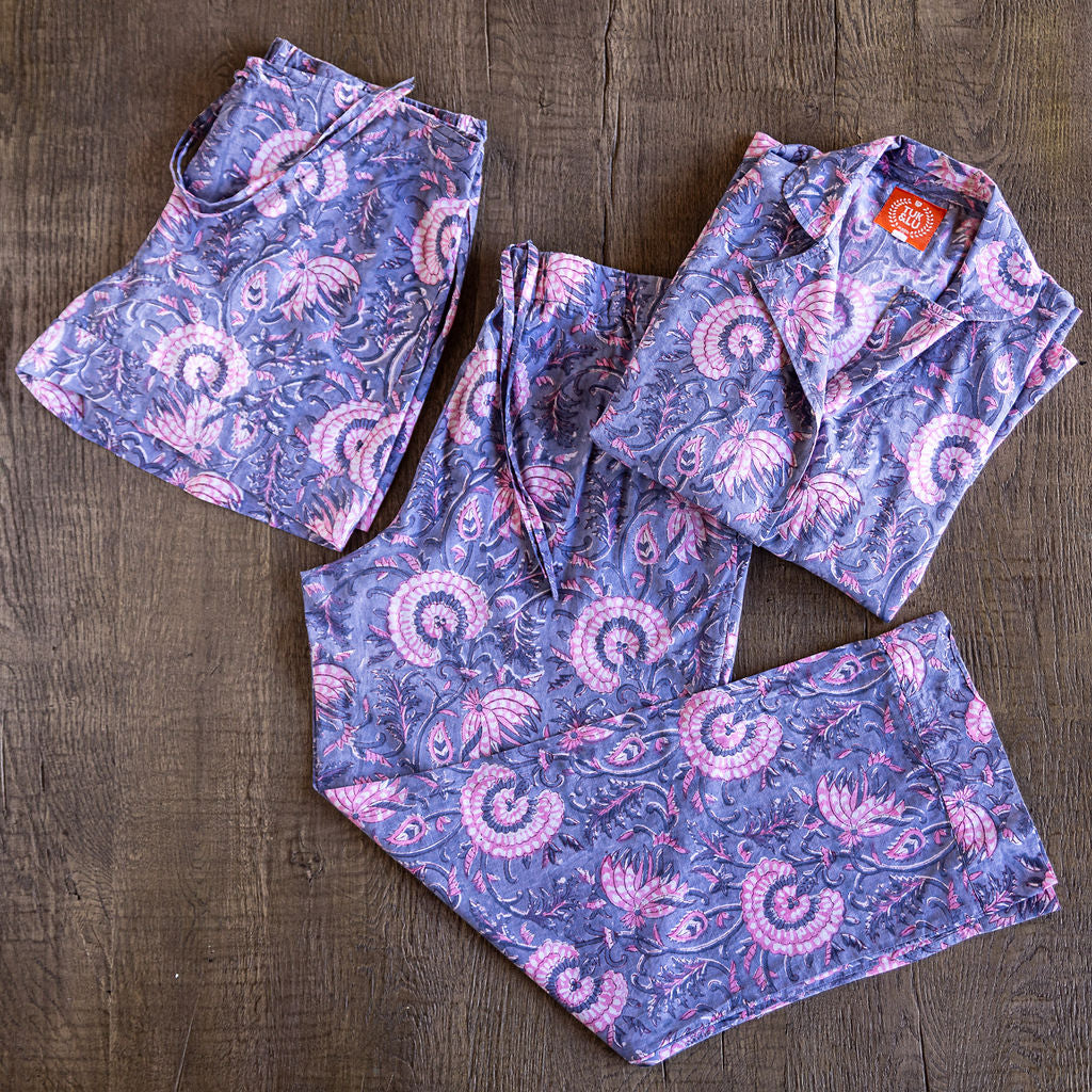 Four piece patterned cotton pajama set featuring button down top, shorts, pants and matching tote.