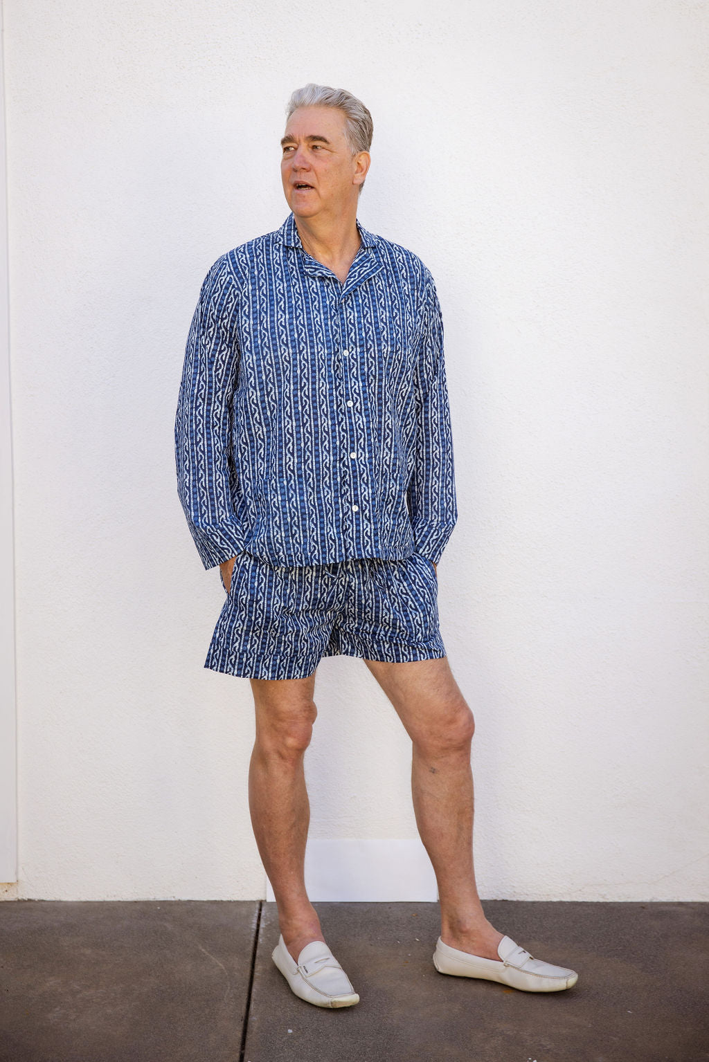 Men's Four piece patterned cotton pjs featuring button down top, shorts, pants and matching tote. Short. Blue pattern.