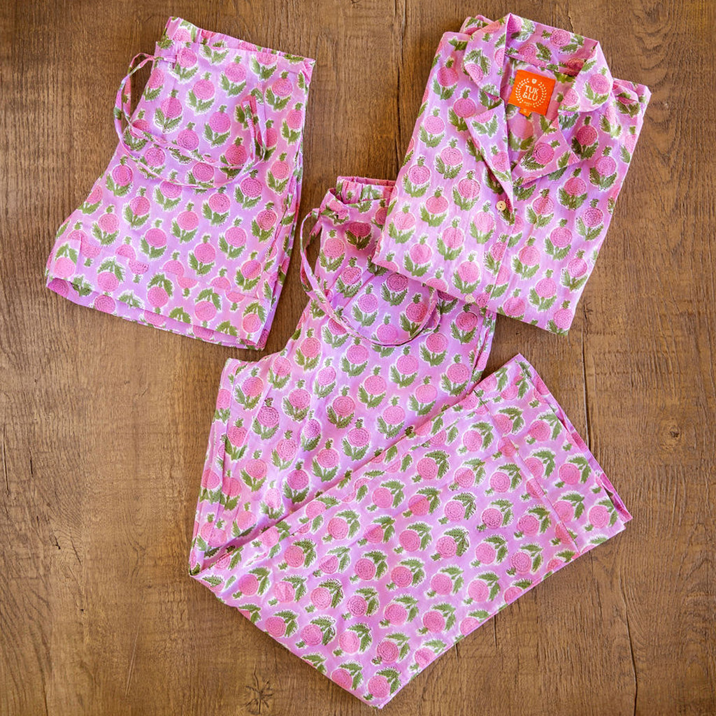 Four piece patterned cotton pjs featuring button down top, shorts, pants and matching tote. Pants and shorts with pockets. Pink floral design. 