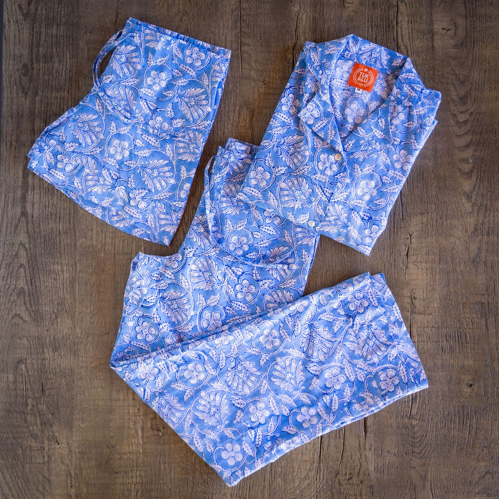 Four piece patterned cotton pajama set featuring button down top, shorts, pants and matching tote.