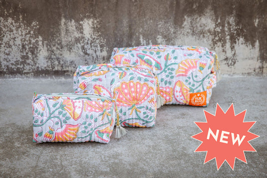 Set of three floral patterned cotton cosmetic bags. Smaller bags fit into the largest for easy storage.
