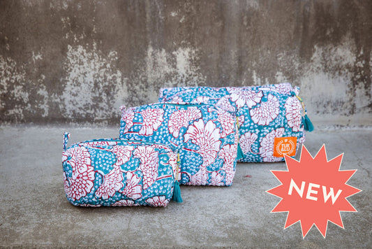 Set of three blue patterned cotton cosmetic bags. Smaller bags fit into the largest for easy storage.