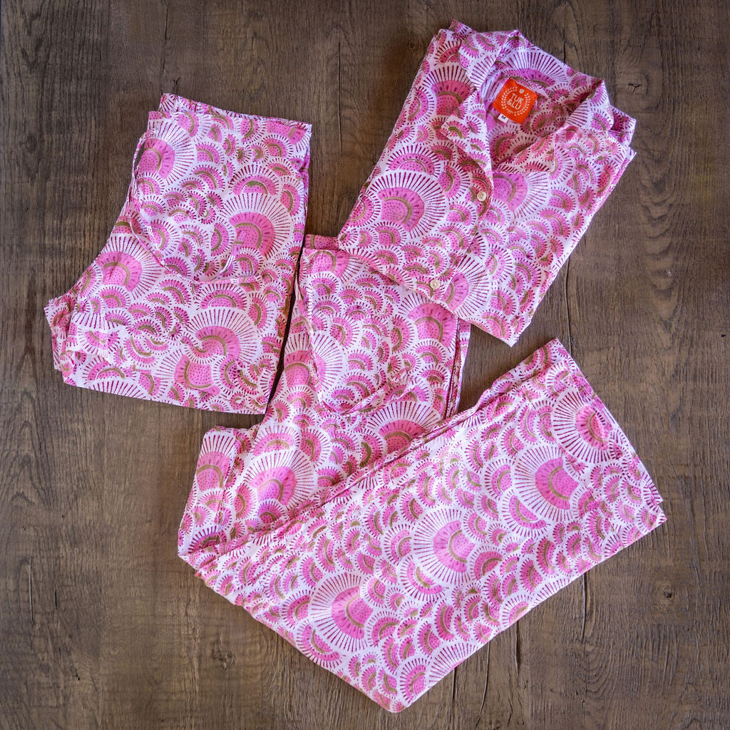 Pink four piece patterned cotton pjs featuring button down top, shorts, pants and matching tote.