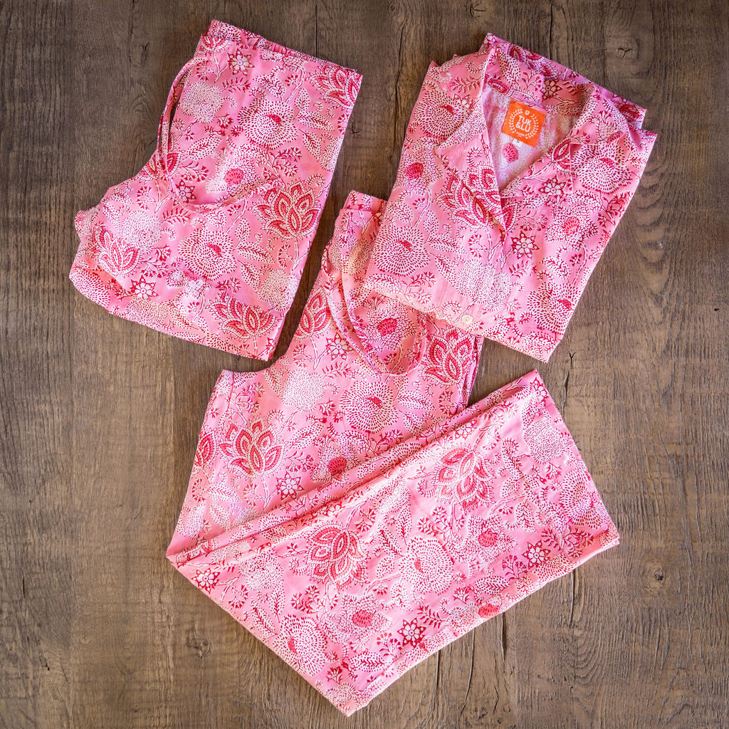 Four piece patterned cotton pjs featuring button down top, shorts, pants and matching tote. Pink.