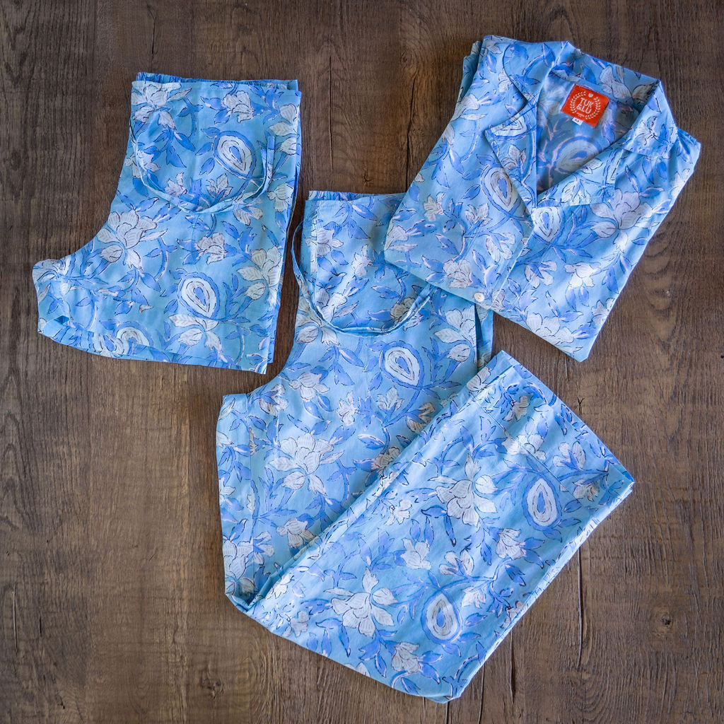 Four piece patterned cotton pjs featuring button down top, shorts, pants and matching tote.