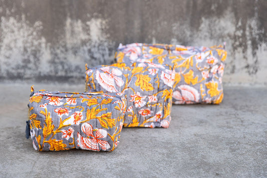 Set of three multi-colored patterned cotton cosmetic bags. Smaller bags fit into the largest for easy storage.