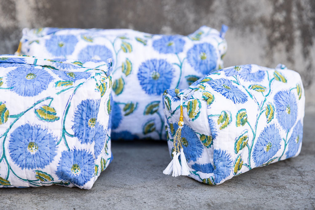 Set of three multi-colored patterned cotton cosmetic bags. Smaller bags fit into the largest for easy storage. Detail
