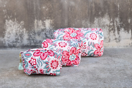 Set of three multi-colored patterned cotton cosmetic bags. Smaller bags fit into the largest for easy storage. Floral pattern.
