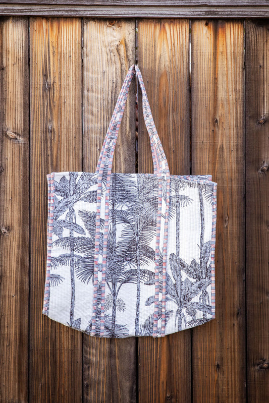 Cotton, reversible, machine washable, structured tote bag with pockets. Palm tree themed.