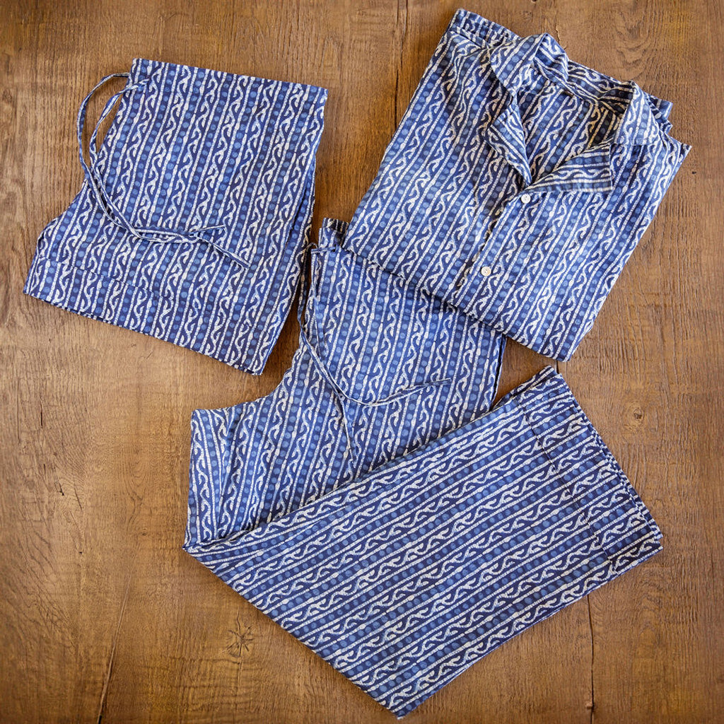 Four piece men's patterned cotton pjs featuring button down top, shorts, pants and matching tote. Blue pattern.