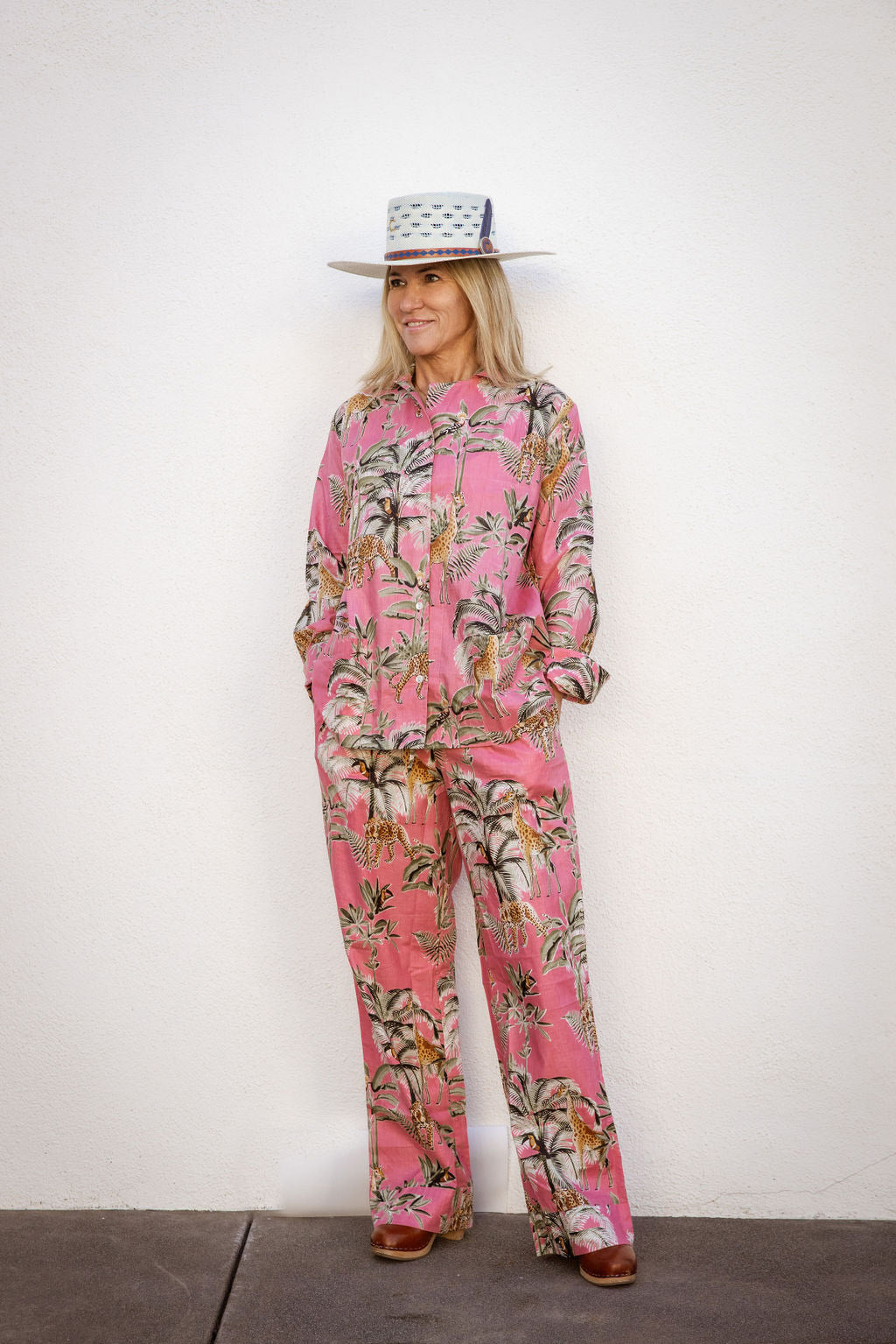 Model wearing Tuk and Lu's pink jungle patterned cotton PJ set with the pant. Also comes with shorts and tote.