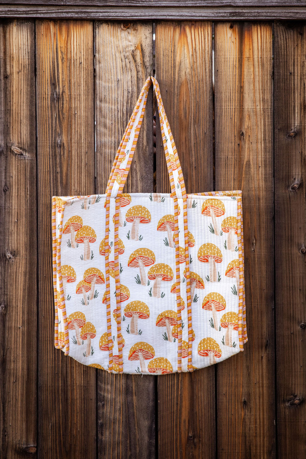 Cotton, reversible, machine washable, structured tote bag with pockets. Yellow mushroom pattern.