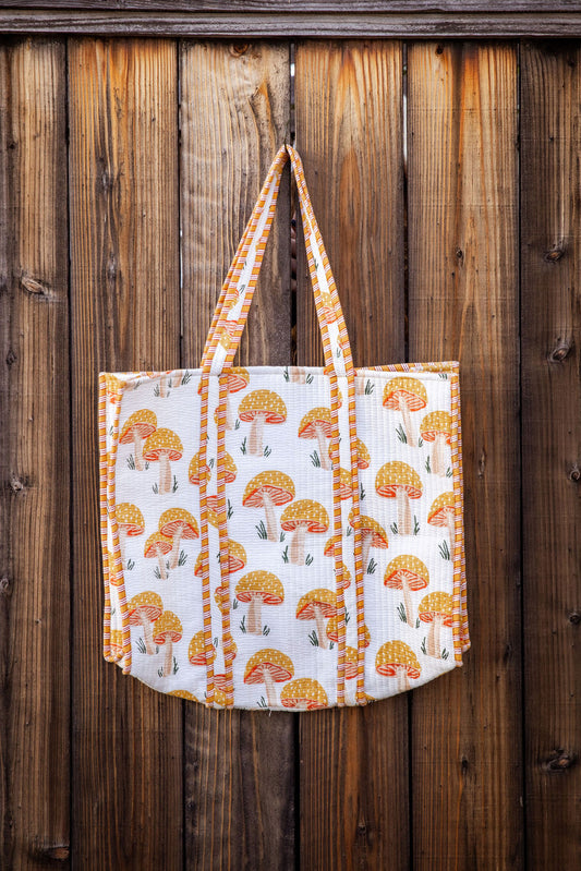 Cotton, reversible, machine washable, structured tote bag with pockets. Yellow mushroom pattern.
