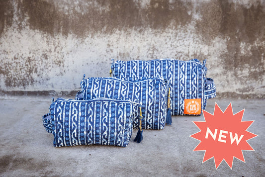 Set of three floral patterned cotton cosmetic bags. Smaller bags fit into the largest for easy storage. Blue pattern.