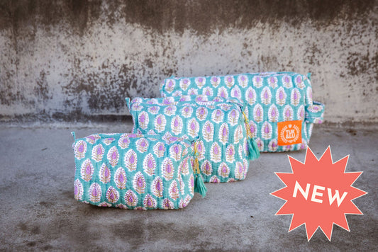 Set of three floral patterned cotton cosmetic bags. Smaller bags fit into the largest for easy storage. Paisley on turquoise.