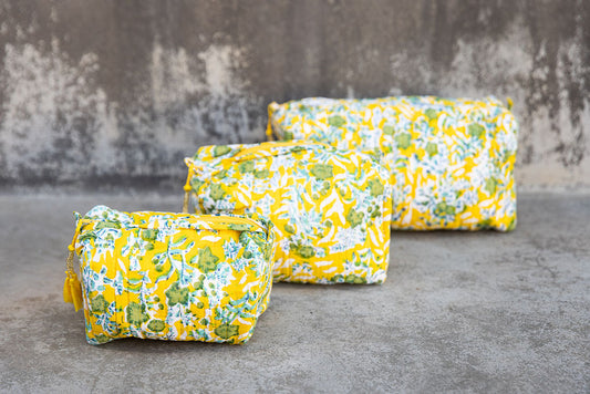 Set of three multi-colored patterned cotton cosmetic bags. Smaller bags fit into the largest for easy storage.