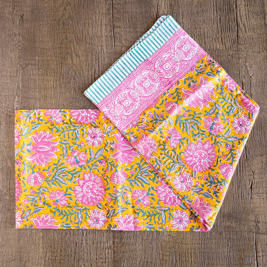 Image of model displaying Tuk and Lu's Sarong. Can be use as a shawl or cover up. Beautiful pink, green and yellow floral pattern.